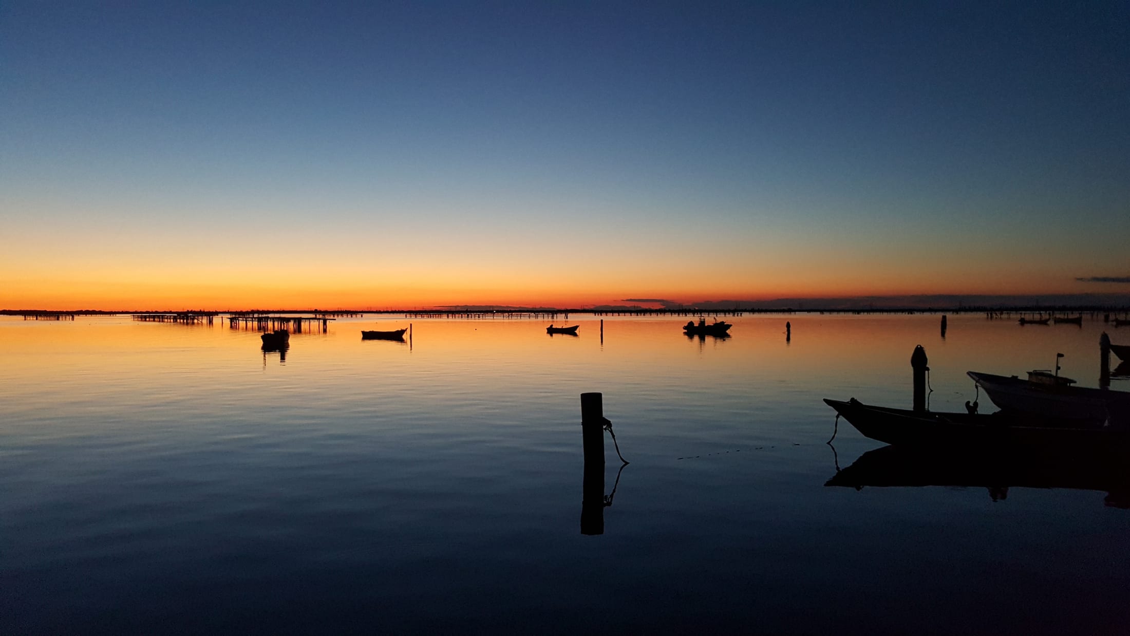 L'ora blu sulla laguna del Delta, con le barche all'ormeggio